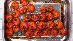 Roasted tomatoes in a baking pan.