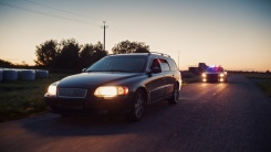 Police Officers in Squad Car Chasing Suspect on Industrial Road