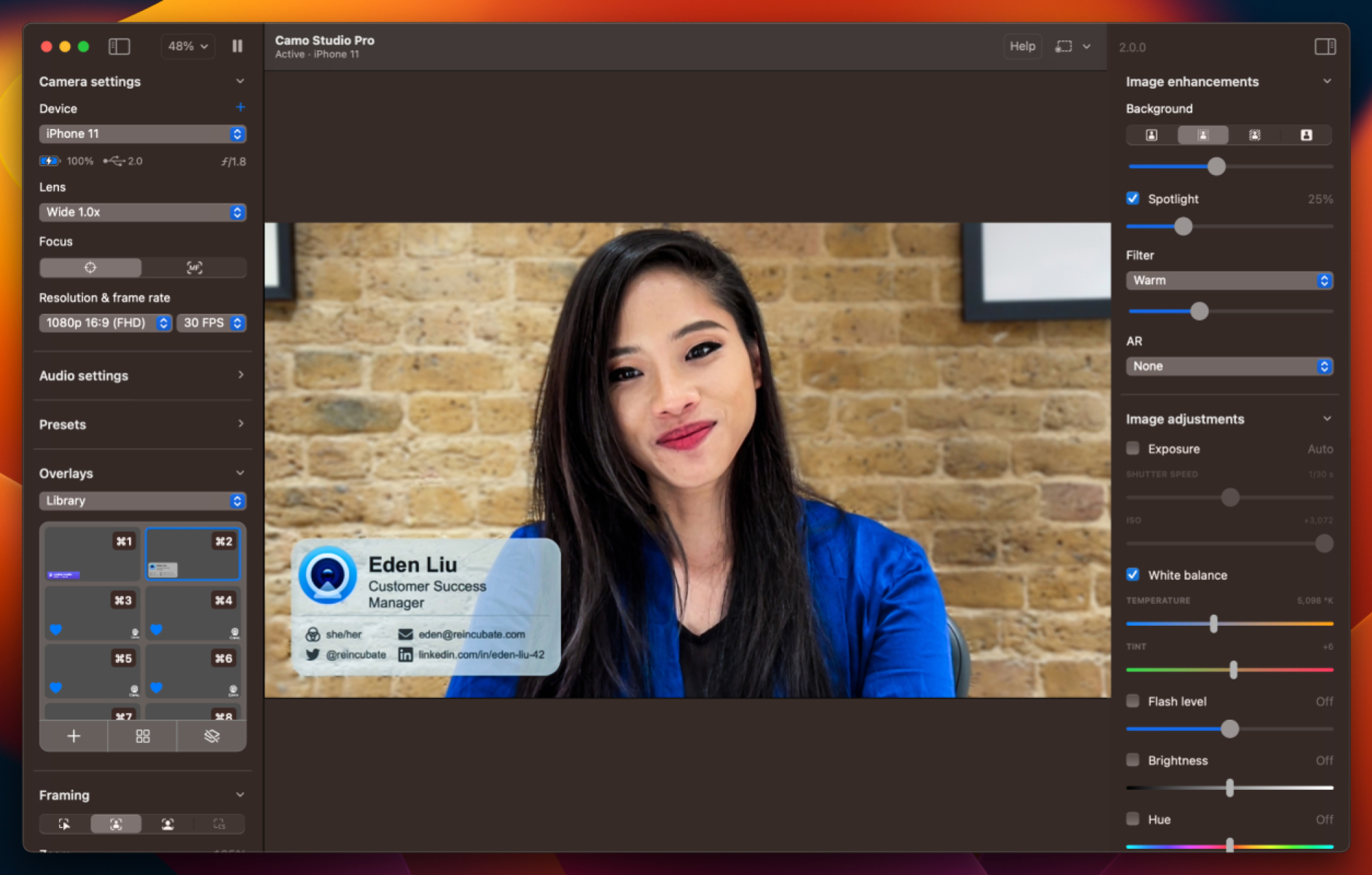 The Camo app running on a Mac. The center has a woman in the frame with a brick wall in the background. The left and right panes are full of video settings.